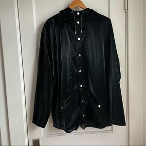 Rains jacket M/L liquid black color. Never worn. Great Details M/L